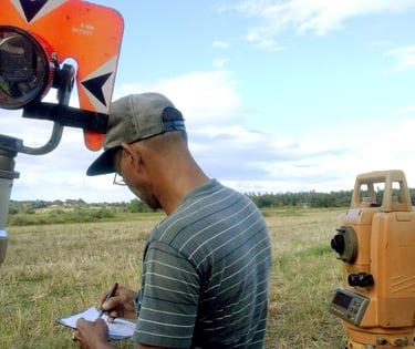 Licensed Surveyor Engineer conducting land survey or land surveying, construction survey