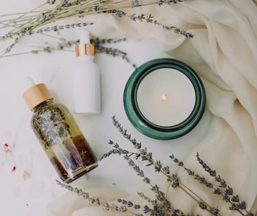  a candle on a table with face oil 