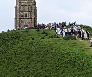Spiritual seekers climbing Glastonbury Tor