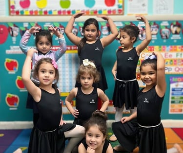 a group of young girls in black dresses and ballet shoes FANTASTIC LAND LEARNING CENTER