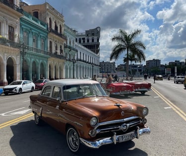 a classic car parked on the side of a street cuba
