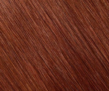 Close-up of straight auburn hair texture with shiny copper highlights and mahogany tones.