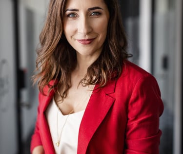 a woman in a red jacket and white top