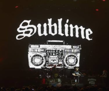 The band Sublime performing on stage with a large boombox graphic and logo backdrop.
