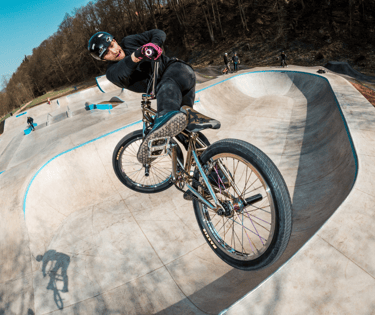 a man riding a bike on a ramp in a skate park