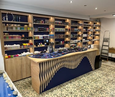Modern vape shop interior with shelves of e-liquids and a display counter of vaping devices.