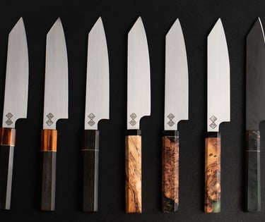 a set of five baltic blades chef knives and knives on a black background