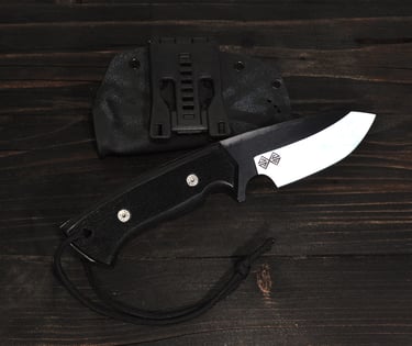 a baltic blades SERE knife - cut knife and a knife on a wooden table