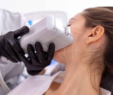 sideview of woman's cheek getting HIFU skin tightening treatment with hand held machine
