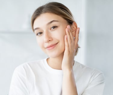 woman with clear skin touching own face