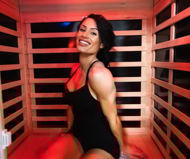woman in a black swimsuit sitting in a infrared sauna ms bikini olympia international jennifer dorie