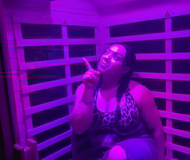 a woman in a leopard print dress sitting in a infrared sauna with halotherapy active salt therapy