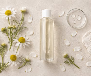 Roman chamomile water bottle surrounded by Chamaemelum nobile flowers