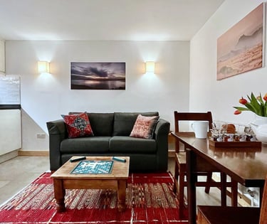 a lounge area with kitchen and dining space