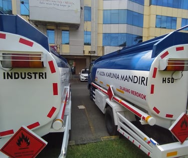 a truck with a tanker and a trailer behind it