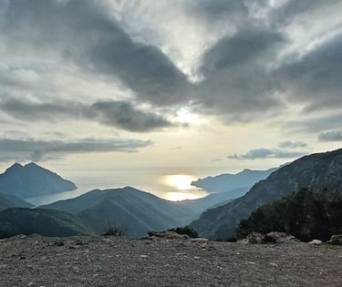 a person sitting on a bench in the mountains