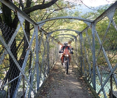 a man riding a bike on a bridge