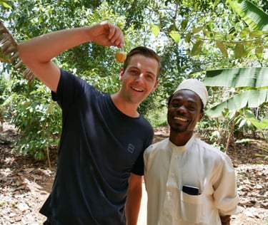 Smiling tourist enjoying a fun photo with a friendly local guide after an exciting Zanzibar spice tour at a traditional spice