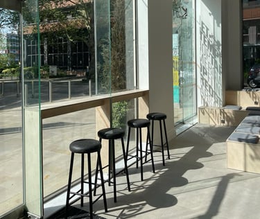 Bar seats with view from window toward Ealing borough and Dickens Yard plaza