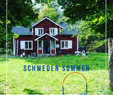 a house with a red house in the background and a white frame with a blue