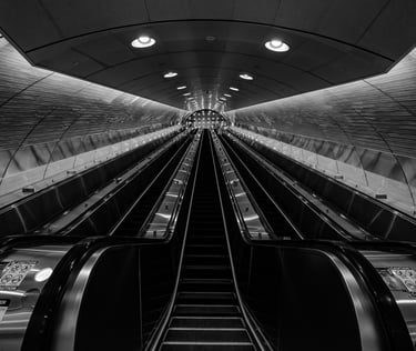 black and white photo of the escalators in grand central terminal