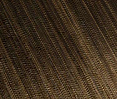 Close-up texture of silky ash brown hair extensions with subtle blonde highlights.