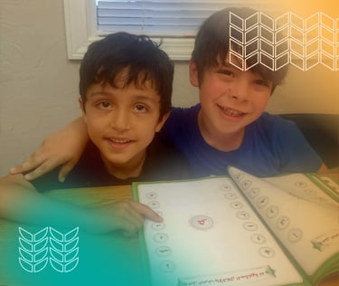 two boys are smiling and holding a book