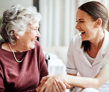 nurse and elderly woman holding hands