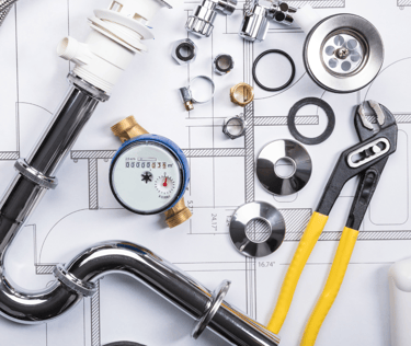 a variety of plumbing tools on a table