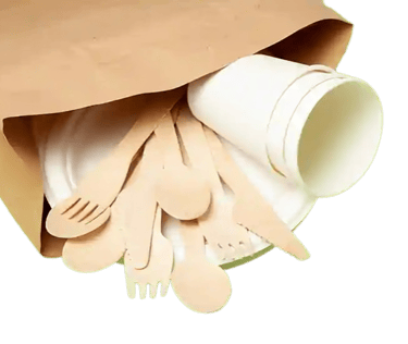 a paper bag with wooden spoons