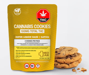 A yellow package of Super Lemon Haze Sativa Cannabis Cookies containing 100mg THC next to a stack of chocolate chip cookies.