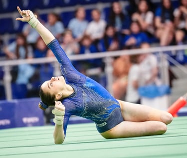 Gymnast performing a floor routine pose at a competitive gymnastics event in Jesolo