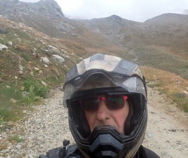 a man in a helmet and a helmet on a motorcycle