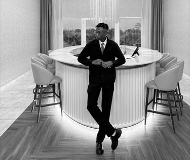 reed in a suit and tie standing infront of a bar