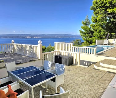 The photo depicts the courtard dining set as well as parts of the eastern sun terrace and pool.