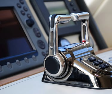 Dual boat throttles with marine electronics in the background.