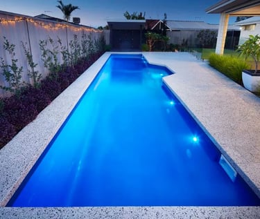 Contemporary lap pool with vivid blue water, smooth interior finish and light aggregate tiling