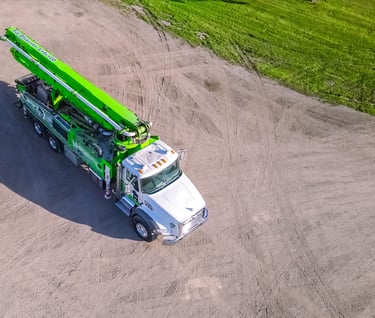 a green crane truck with a crane on it