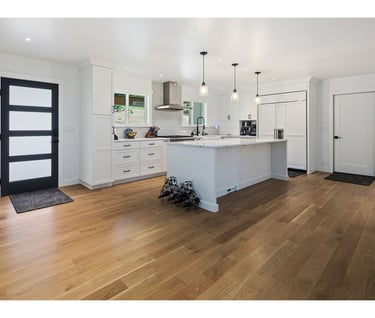 a kitchen with a large island and a wooden floor
