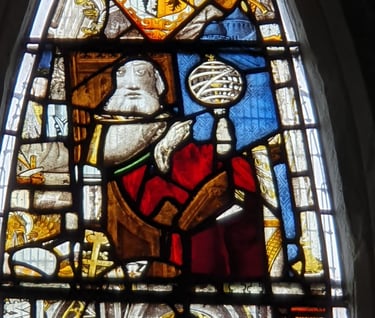 Detail of the East Window at All Saints Church, Landbeach. Figure of a magus with armillary sphere.