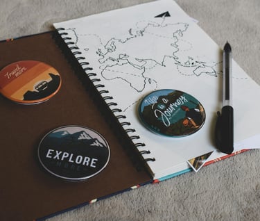 a notebook with a pen and a notebook with a map of the world
