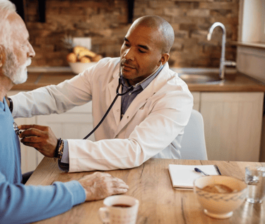 a doctor checking an elderly's heartbeat