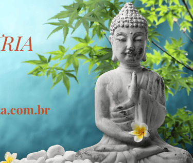 uma estátua de buda sentada em uma pedra com uma flor em primeiro plano