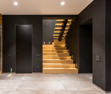 a staircase leading to a wooden staircase