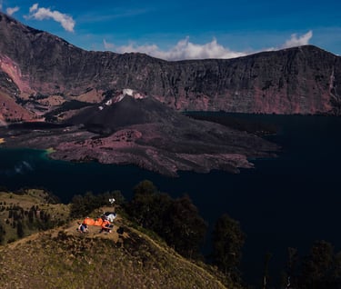 a group of people standing on a mountain top named Rinjani