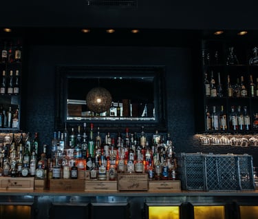 a bar with a lot of bottles of alcohol