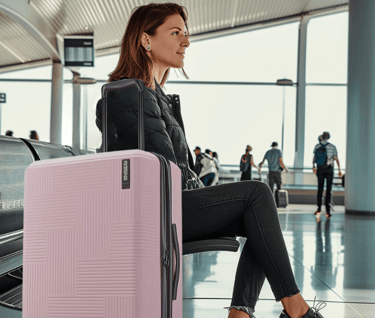 a woman sitting on a bench in a airport