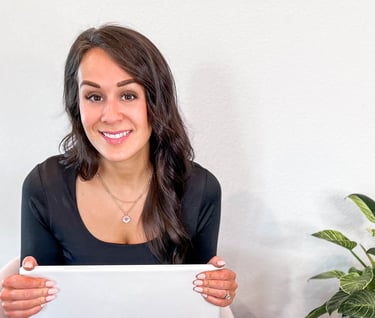 Woman holding laptop and smiling
