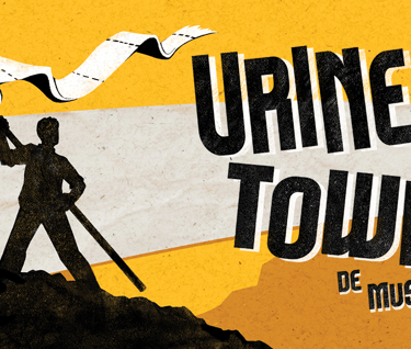 a man holding a flag that says urine town