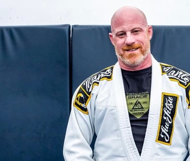 a man in a white gi and bjj black belt